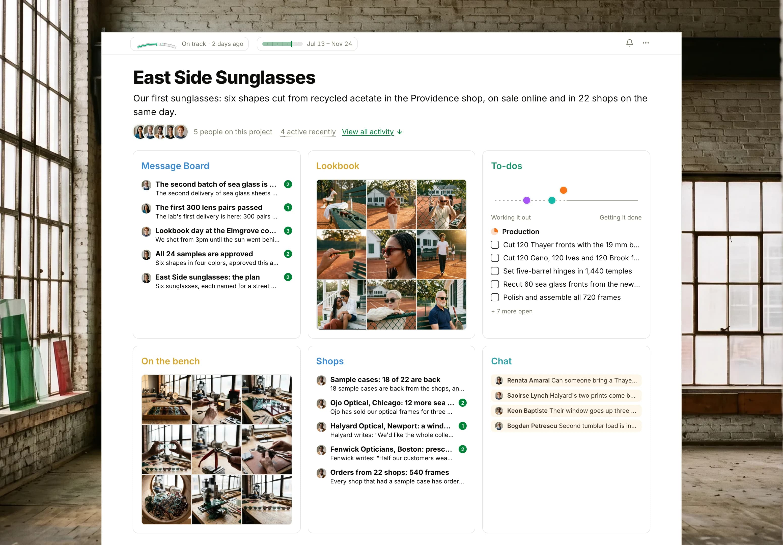 The East Side Sunglasses project in Thicket over a photograph of colored acetate sheets glowing in tall factory windows: the health flag reading On track, the dates and five people, then six cards: the Message Board with the cloudy sea glass batch on top, Lookbook as nine photographs of models wearing the sunglasses at a clay tennis court, To-dos with three lists on the progress chart, On the bench as nine photographs of the frames being cut, finished and fitted with lenses, Shops with the newest requests from shops, and Chat with this morning's lines from the workshop.