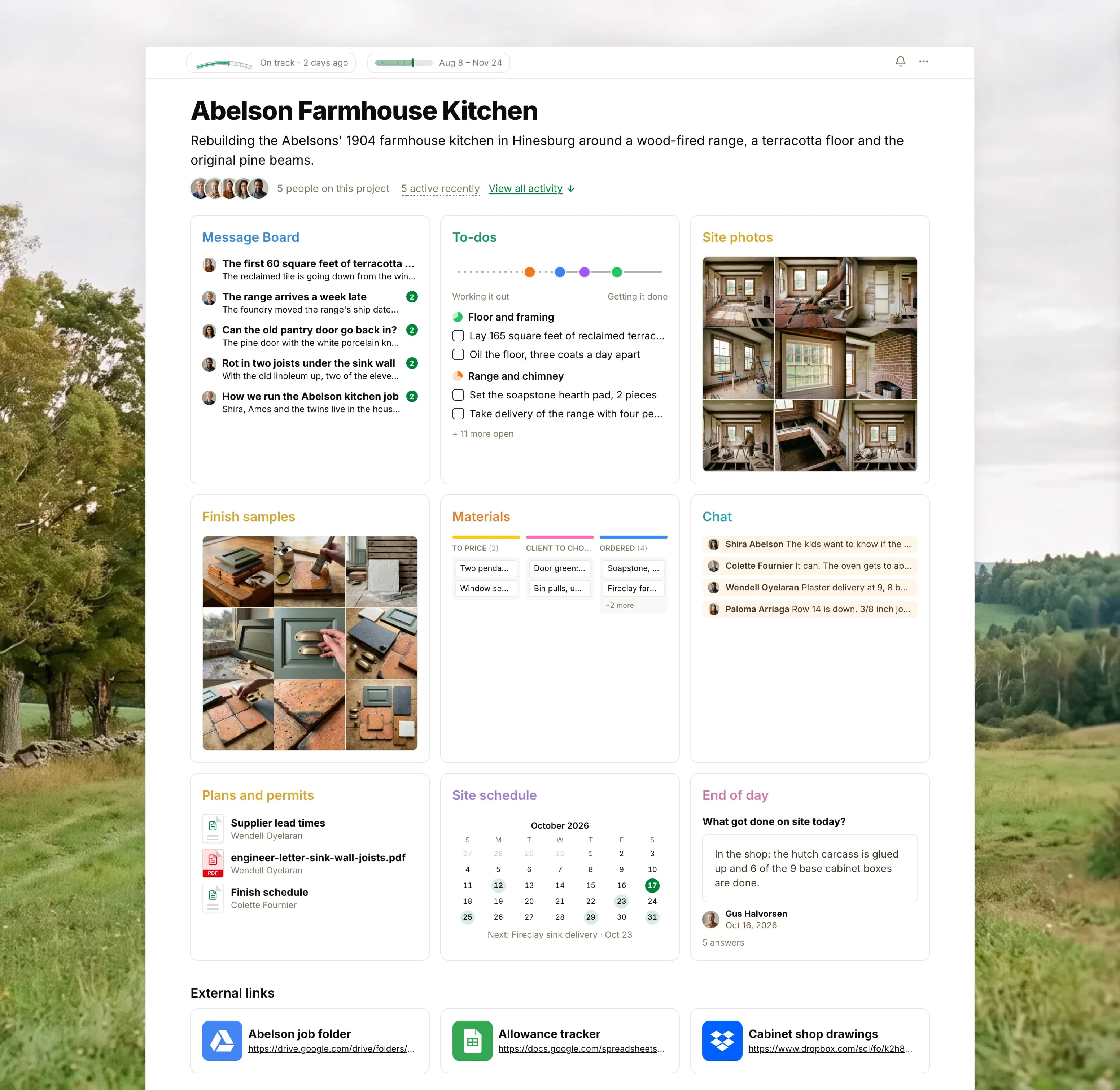 The Abelson Farmhouse Kitchen project in Thicket over a photograph of a hay meadow and old sugar maples: the health flag reading On track, the job's dates and five people, then nine cards: the Message Board with the first terracotta floor tiles on top, To-dos with four lists on the progress chart, Site photos as nine pictures of the kitchen during the work, Finish samples as nine pictures of terracotta, soapstone, brass and green paint, the Materials board with cards in To price, Client to choose and Ordered, Chat between the crew and the homeowner, Plans and permits with the supplier lead times and the engineer's letter, the Site schedule with the inspections and the range delivery, and the End of day check-in, with three external links below.